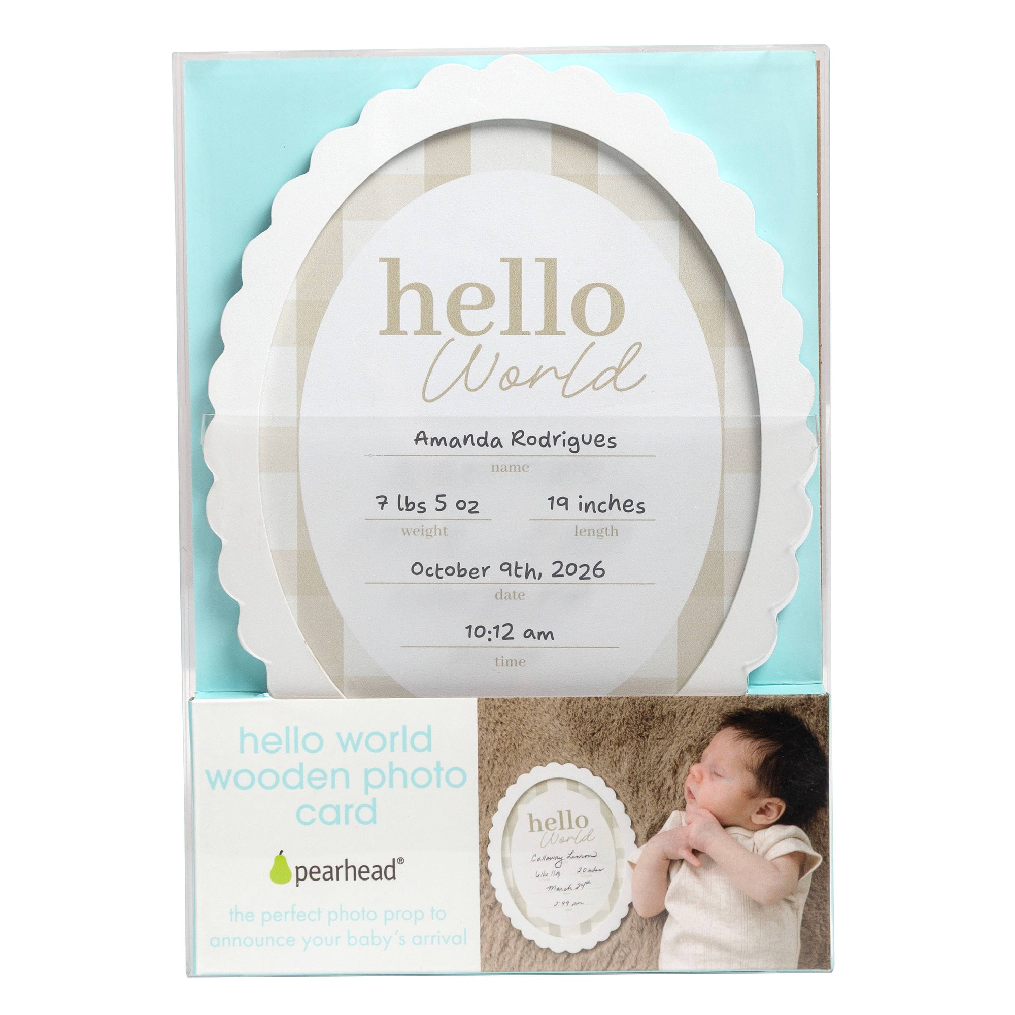 Pearhead Hello World wooden photo prop card in its retail packaging, featuring a scalloped white oval frame design with customizable text and a small photo of a baby on the lower right.
